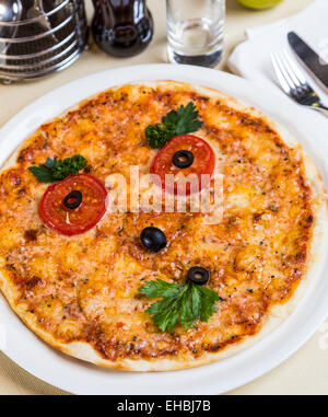 Restourant serving dish for child`s menu - pizza with face Stock Photo